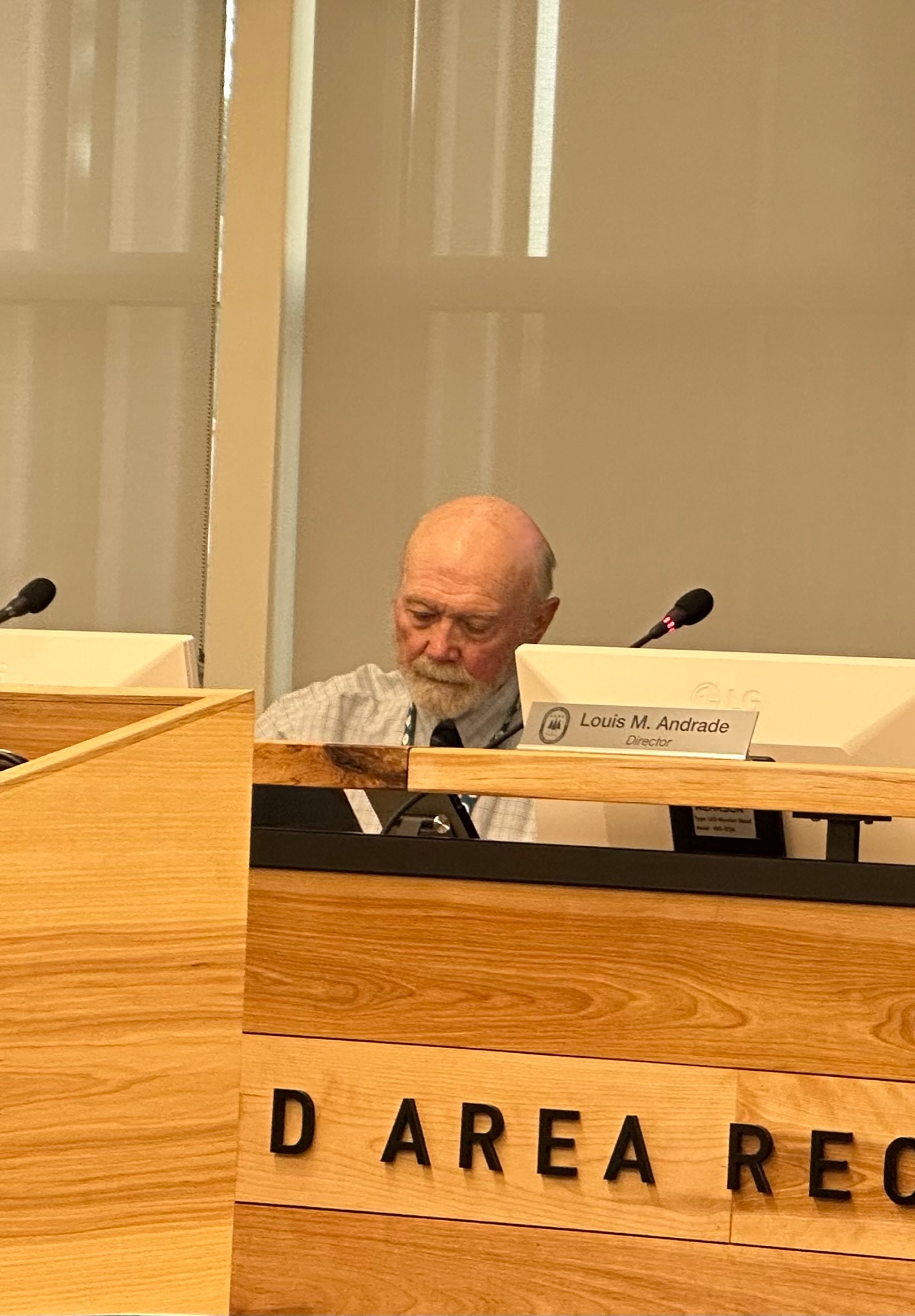 Director Paul W. Hodges, Jr. seated at a H.A.R.D. Board meeting